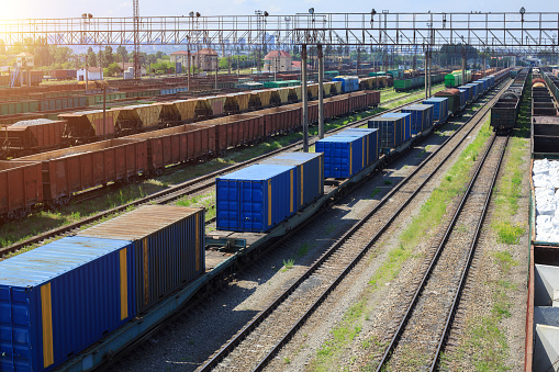 Freight trains on city cargo terminal. Railways in train parking. Arain arrived at the station. Cargo train platform with freight train container at depot in port use for export logistics background.