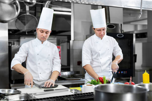 istock Restaurant Busy Kitchen, Chefs and Cooks Working on their Dishes. 1646377658
