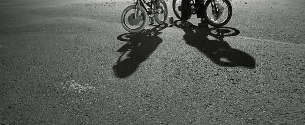 istock two young riders bike and shadows at night 164637781