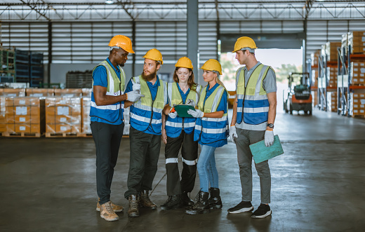 Multicultural warehouse staff creates logistical atmosphere that encourages empowerment, confidence. The collaborative and diverse team results in excellent performance and a strong sense of unity.