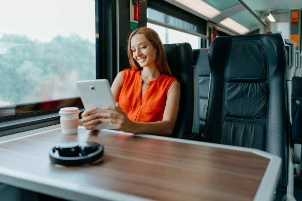 istock Woman immersed in her tablet on the train 1646378715