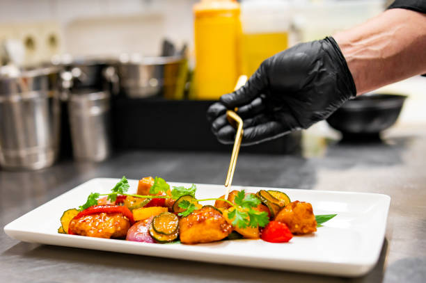 istock chef cooking chicken sweet and sour sauce on kitchen 1646380490