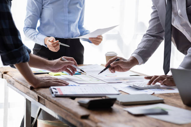 istock Financial analysts analyze business financial reports on a digital tablet planning investment project during a discussion at a meeting of corporate showing the results of their successful teamwork. 1646384827