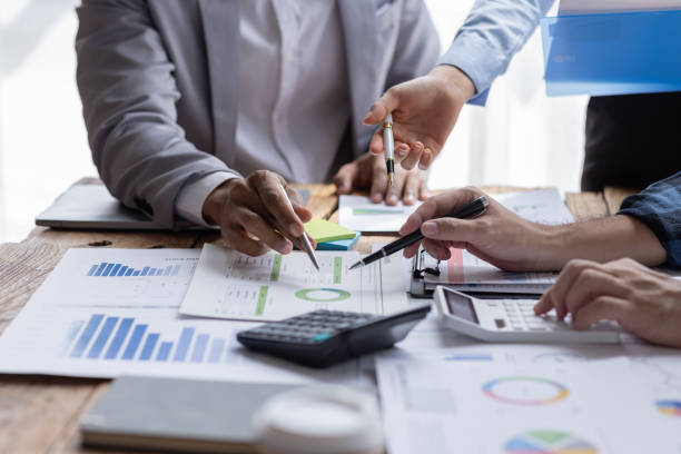 istock Financial analysts analyze business financial reports on a digital tablet planning investment project during a discussion at a meeting of corporate showing the results of their successful teamwork. 1646386535