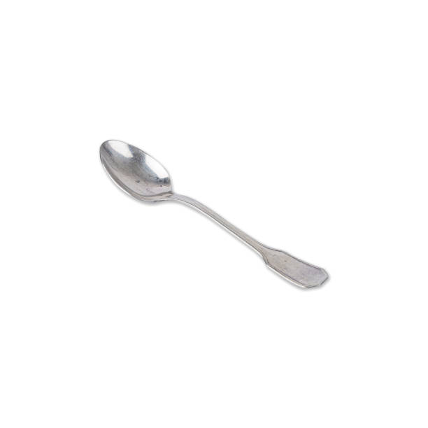istock Old metal spoon isolated over white background 1646387119