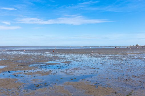 Wadden Sea, people walking on the beach at Low Tide, Norddeich, East-Frisia, Germany