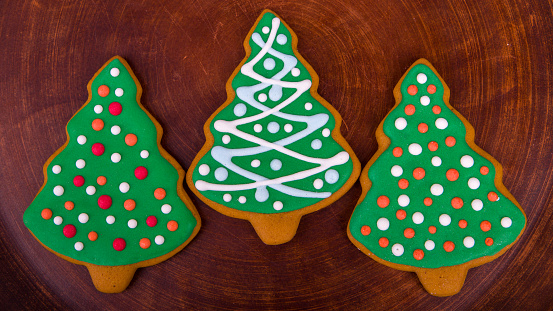 Christmas cookies in the shape of a Christmas tree on a wooden background