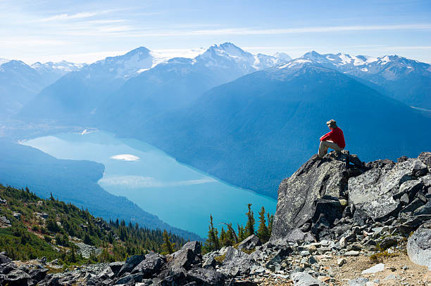Mountain Solitude Hiker in British Columbia's Coast Mountains view from mountain top stock pictures, royalty-free photos & images