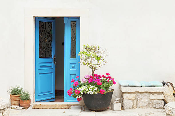 blue door and flower pots with cushion bench facade Croatia blue door and flower pots with cushion bench facade Croatia blue house red door stock pictures, royalty-free photos & images