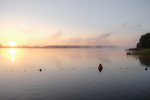Dawn on the river. Buoys line floating on water. Copy space.