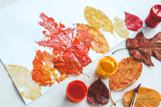 istock Children's autumn activity, leaf print on paper 1646423665