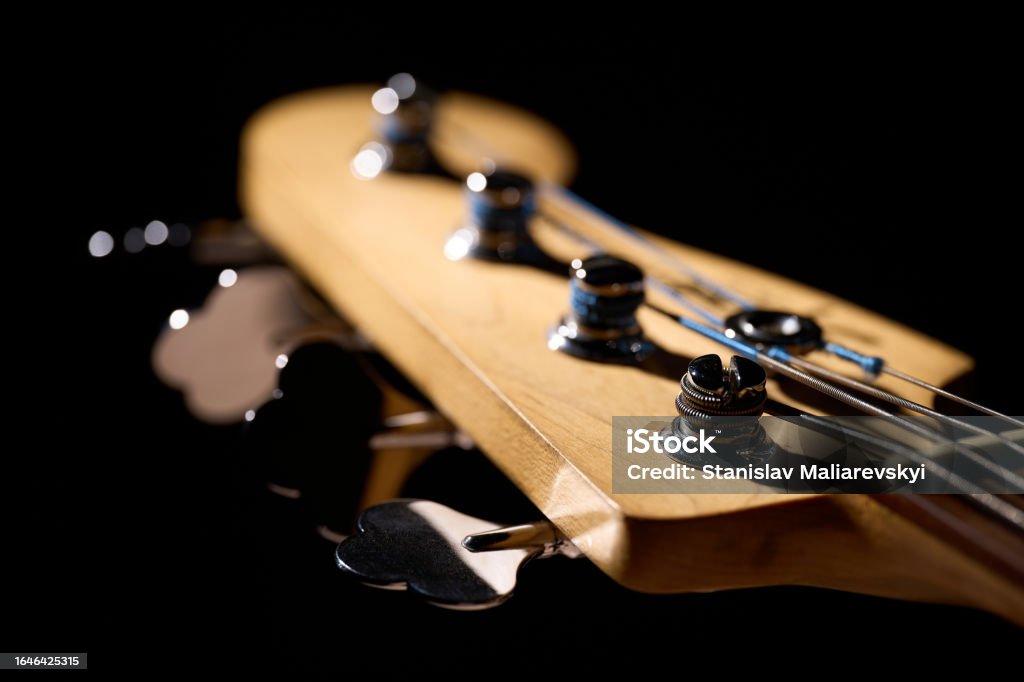 Metallic volume treble guitar bass knobs. Electric guitar. Red electric bass guitar close-up. Musical instrument. Music. Four strings. Grif. Acoustic Blues Stock Photo