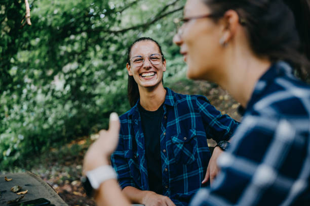 istock Amidst nature's embrace, two friends enjoy, sharing conversations and creating an oasis of laughter 1646430422