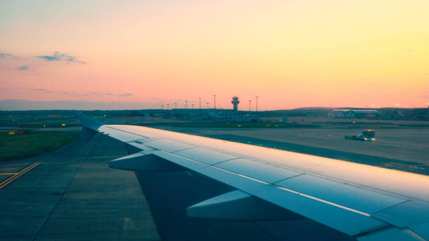 istock Airplane Wing Engine Sunset Tarmac Airport Runway 1646432711