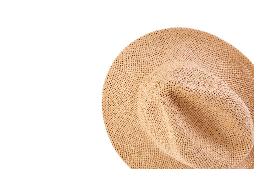 Wicker straw flaxen hat with red ribbon on isolated white background. Fashion accessory. Female summer hat.