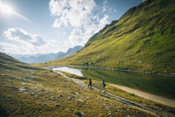 istock Couple hike along lakeshore 1646441020