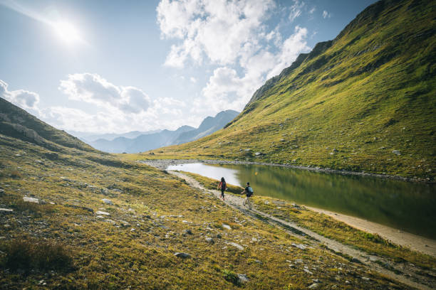 istock Couple hike along lakeshore 1646441588