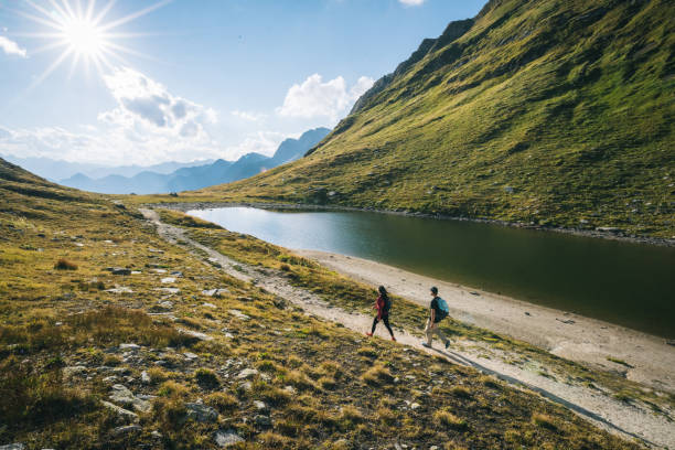 istock Couple hike along lakeshore 1646443392