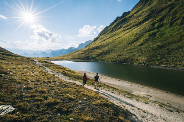 istock Couple hike along lakeshore 1646444139