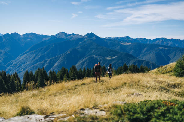 istock Couple hike along a mountain pathway 1646444492