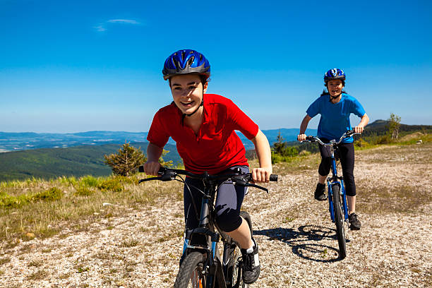 istock Smiling girls in bicycles biking on a field 164644501
