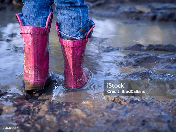 Boots Splashing In Puddle Stock Photo - Download Image Now - Boot, Childhood, Dirty