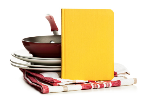 Cookbook and kitchen utensils isolated