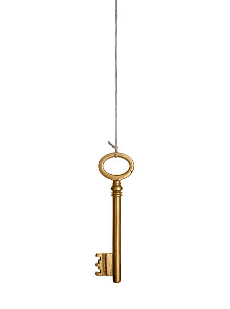 Hanging gold key Gold key, hanging on a string. Isolated on white. tangled photos stock pictures, royalty-free photos & images