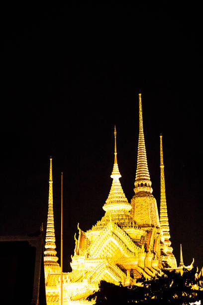Illuminated group of thai stupas at Wat Pho in Bangkok