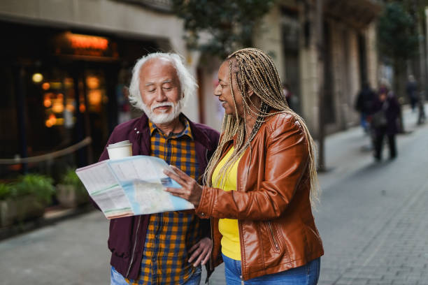 istock Multiracial senior couple having fun together during city trip looking on map - Focus on african woman face 1646483777
