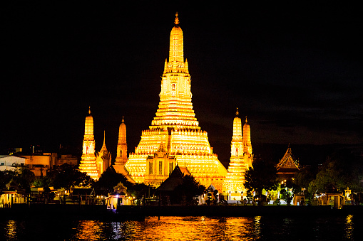 Illuminated cityscape of ancient thai temple Wat Arun in Bangkok