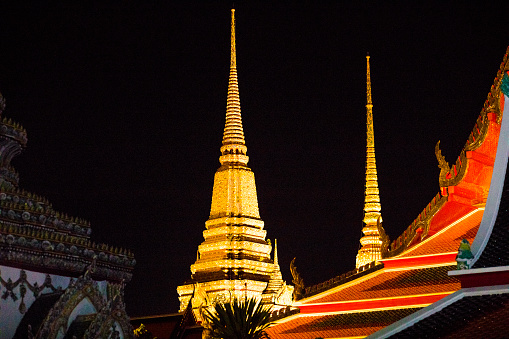 Illuminated big pagoda of Wat Pho in Bangkok at night