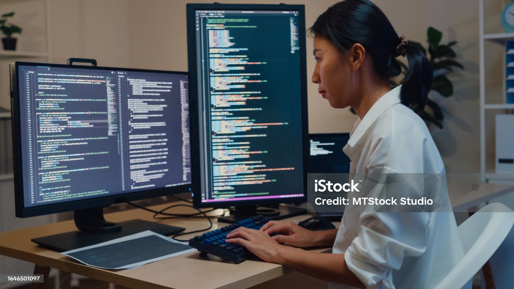 Young Asian Woman Software Developers Using Computer To Write Code ...