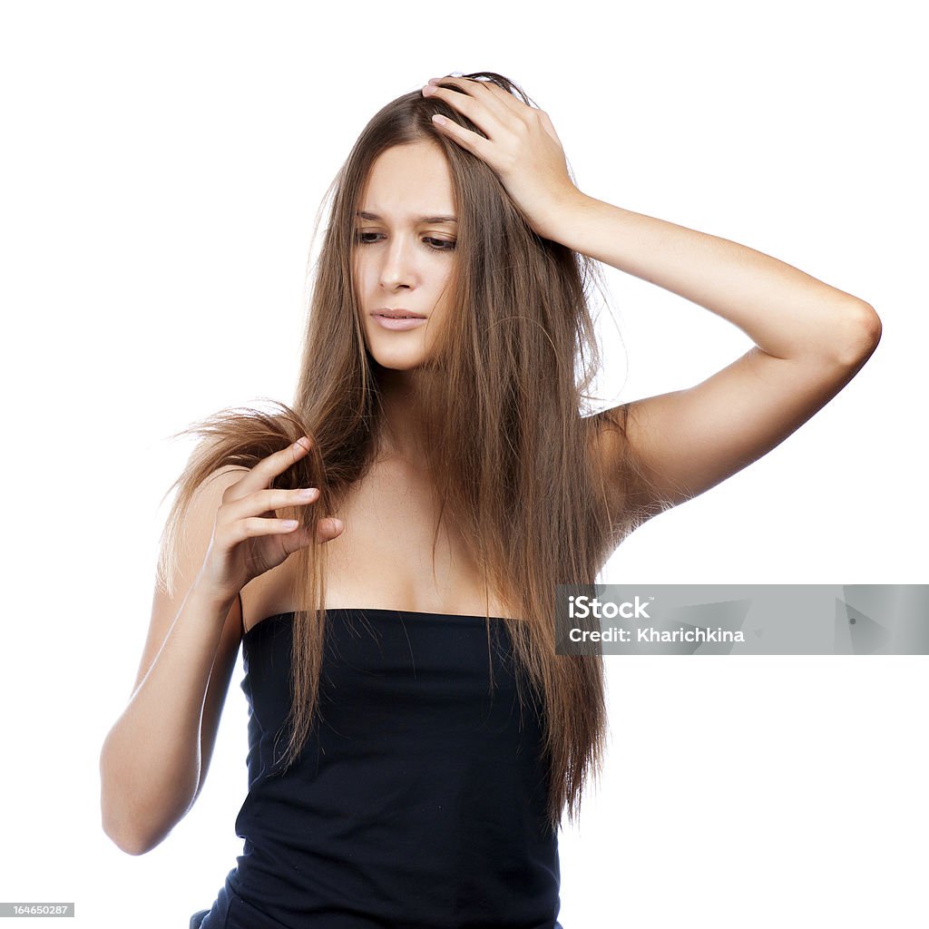 hairstyle portrait of shocked hairstyle portrait of shocked; beautiful brunette girl with creative braid hairdo looking at splitting ends Damaged Stock Photo