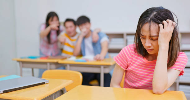istock Asian depressed female student is looking at her mobile phone, and she feels upset 1646504521