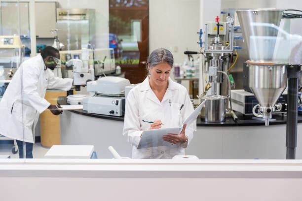 istock Female head lab technician documents results of day's experiments 1646508448