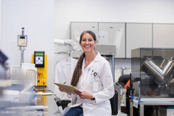 istock Happy female lab tech smiles for camera 1646509594