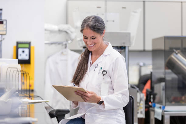 istock Female scientist smiles while reviewing lab results 1646509602