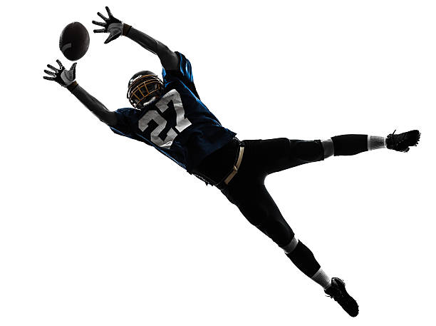 american football player man catching receiving silhouette one caucasian american football player man catching receiving in silhouette studio on white background american football player studio stock pictures, royalty-free photos & images