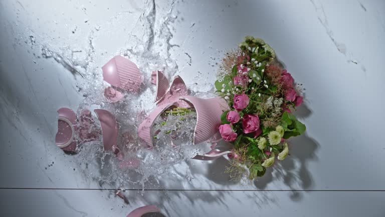 SLO MO LD Pink vase with flowers breaking when hitting the marble floor