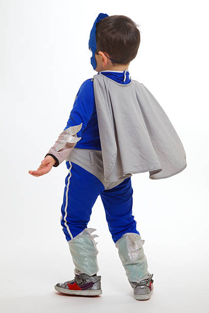 Young boy wearing a superhero suit stock photo