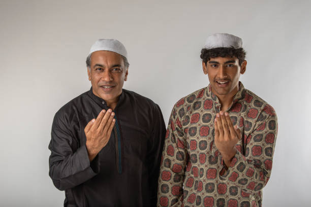 Mature muslim woman in traditional wear praying god.