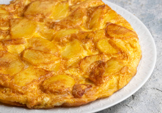 istock Spanish omelette with potatoes, typical spanish cuisine on gray concrete floor. Tortilla Espanola. Turkish name; Yumurtali patates 1646530532