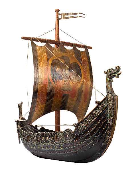 Viking Ship isolated Viking Ship shown at an angle with a dragon head at the bow. The side of the ship has a row of shields. The sail is supported by a wooden mast. The ship is in full focus from the front to the back. The image is isolated on a white background. viking ship photos stock pictures, royalty-free photos & images