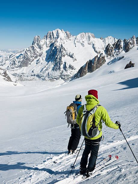 Skiers on the big glacier of Vallee Blanche. stock photo