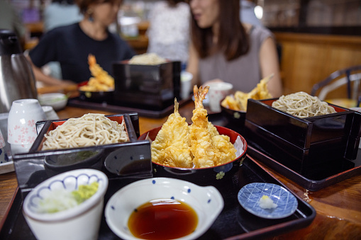 Family visiting Japanese restaurant and eating Tempura soba for lunch