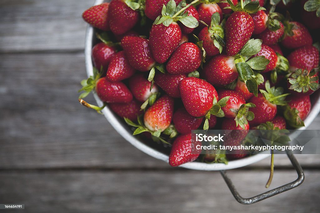Bowl of Strawberries Bowl of strawberries on a picnic table. Berry Fruit Stock Photo