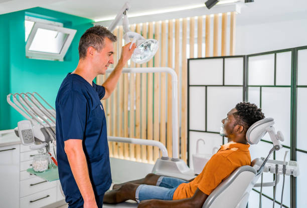istock Man examining his teeth at the dentist 1646542393