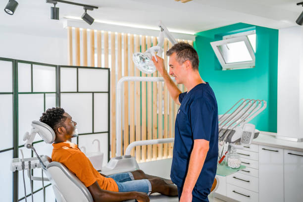 istock Man examining his teeth at the dentist 1646542920