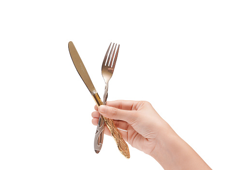 Female Hand Holding A Silver Stainless Fork And Knife Closeup Photo Isolated On White Background